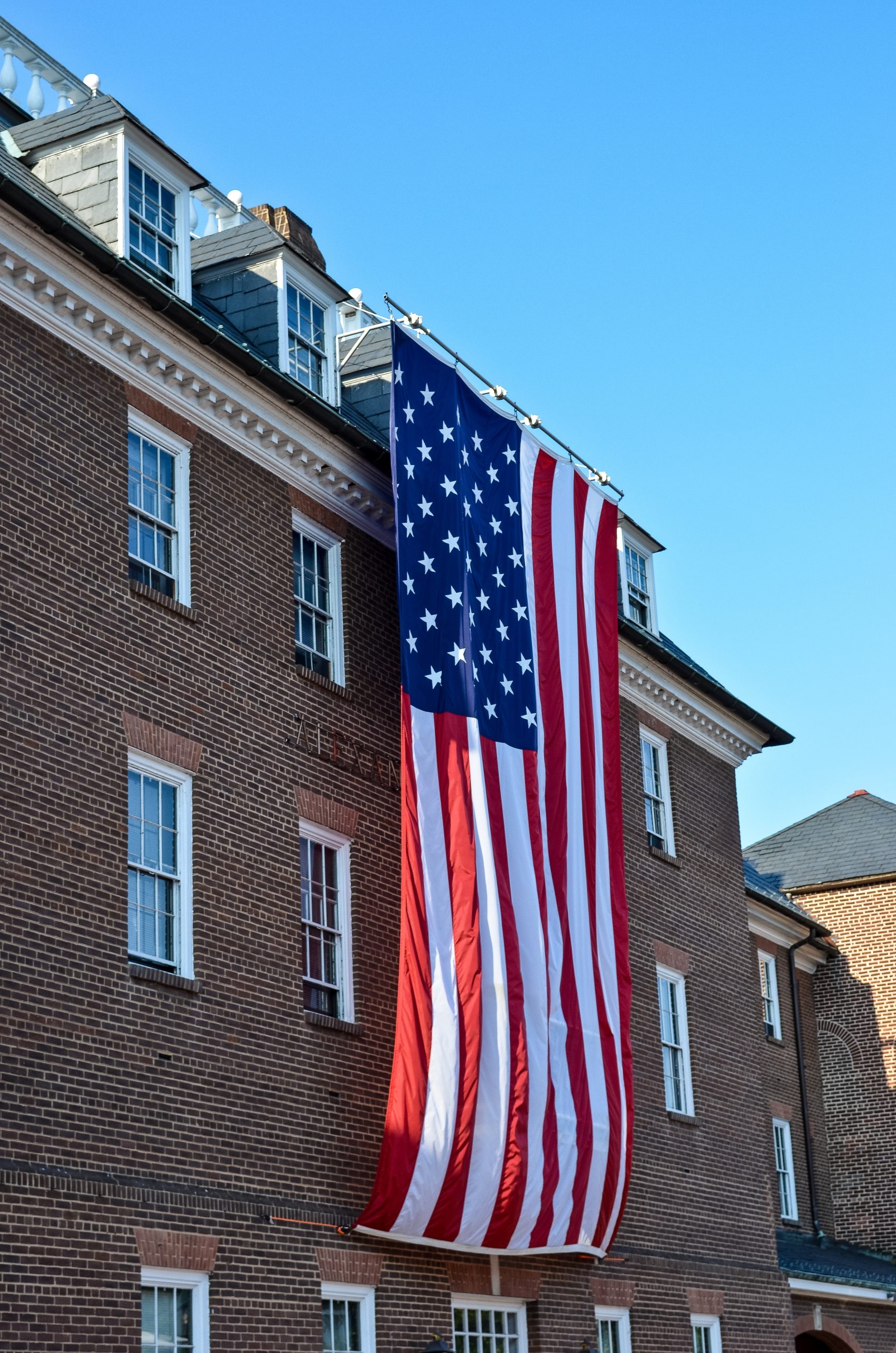 An American flag hanging outside an apartment building