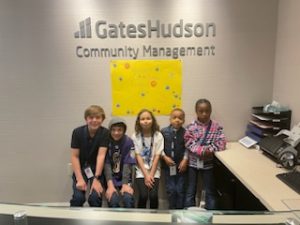 Children posing in front of GHCM sign